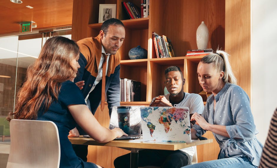 A diverse team of adults discussing ideas in a bright, modern office setting.